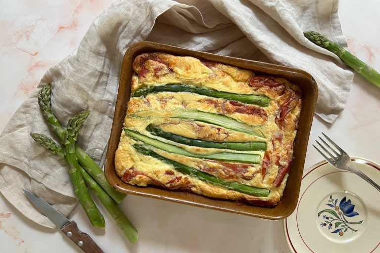 Quiche asperges sans pâte garnie de jambon cru dans un plat rectangulaire