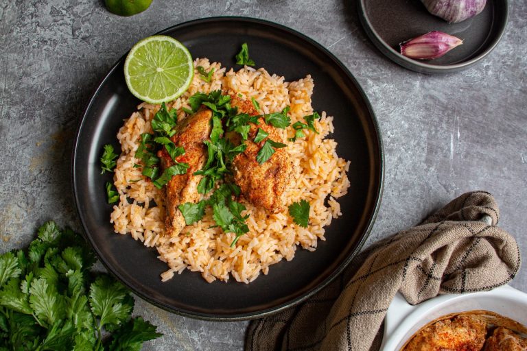 Poulet tandoori épicé sur lit de riz parfumé, garni de coriandre fraîche et citron vert