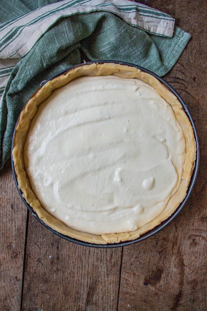 Pâte dorée et garniture crémeuse de tarte au fromage blanc sur fond rustique bois